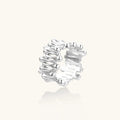 Wide band ring with sculptural wave ripples in polished white gold plated eco-brass on cream background
